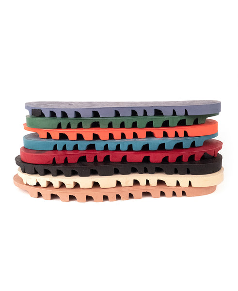 stacked rubber 'BOA' outsoles in various colors: periwinkle, green, orange, teal, red, black, bone and pink